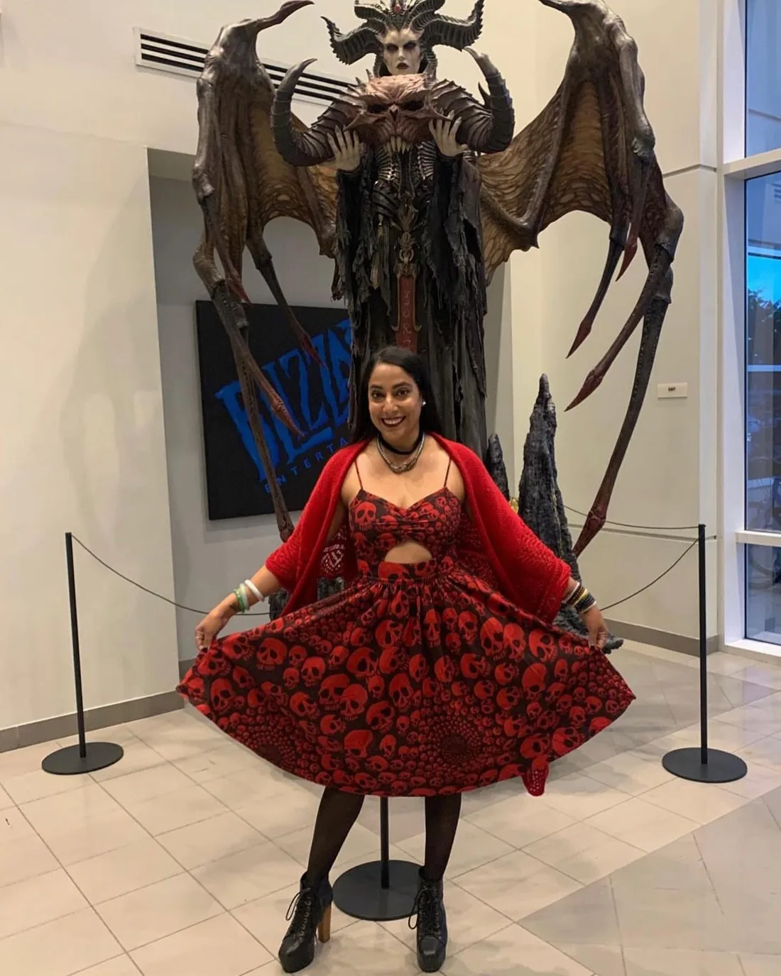 Diandra Lasrado at Blizzard, beside the Lilith statue from Diablo IV